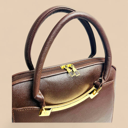 Graciza Elara structured handbag in chocolate brown faux leather with twin handles and polished gold hardware.