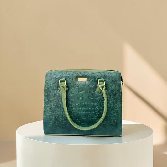 Graciza Lyra green faux leather handbag with crocodile texture and gold hardware on a white pedestal