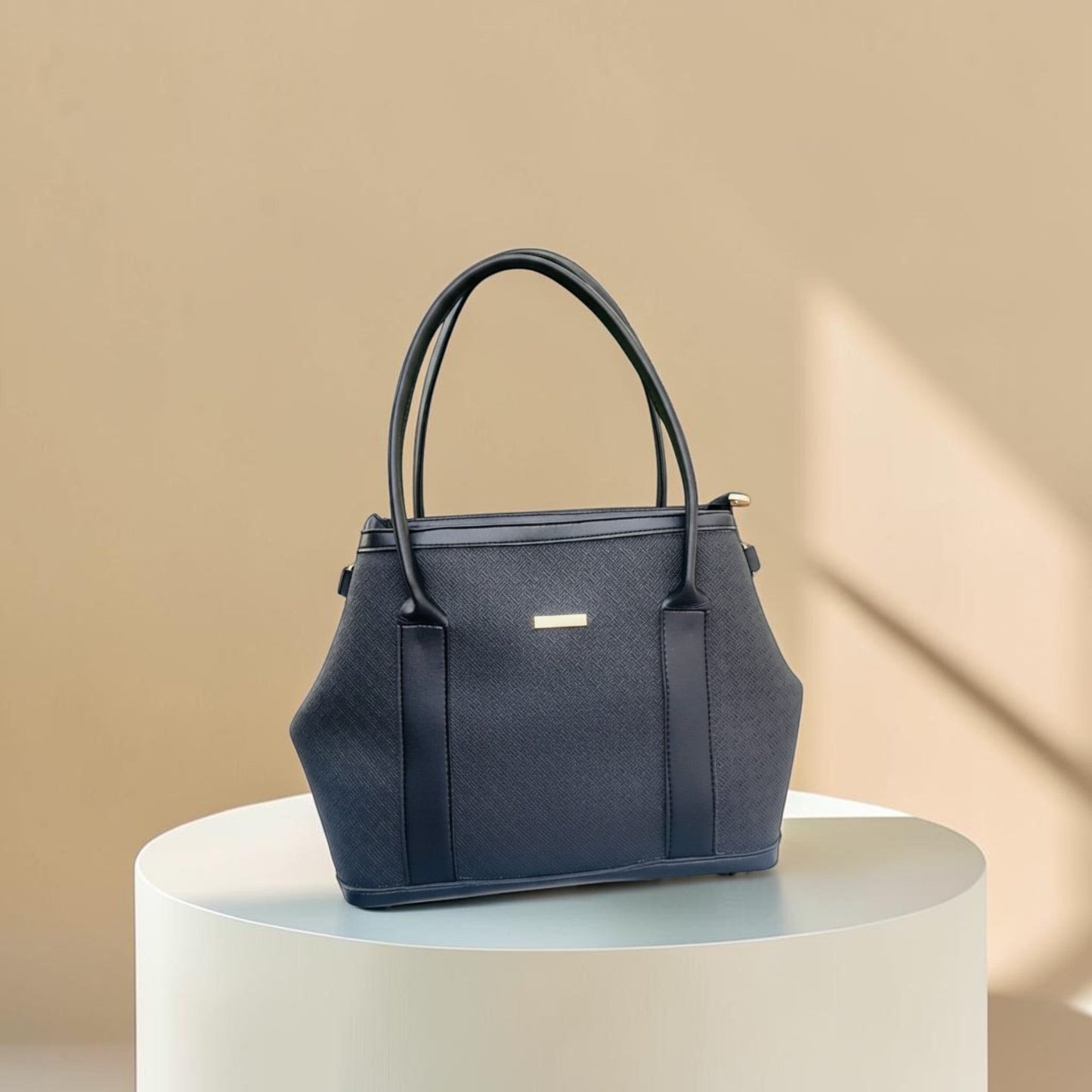 Graciza black Aero shoulder bag with flared wings, faux leather texture, and minimalist gold bar hardware.