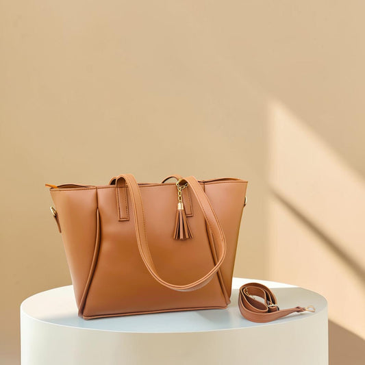 Graciza Aura brown faux leather tote bag with gold hardware, decorative tassel, and removable shoulder strap.