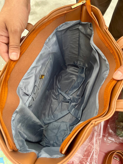 Interior view of Graciza Aura brown faux leather tote bag with grey lining, zipper closure, and gold hardware.
