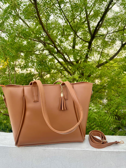 Graciza Aura brown faux leather tote bag with gold hardware, decorative tassel, and removable shoulder strap.