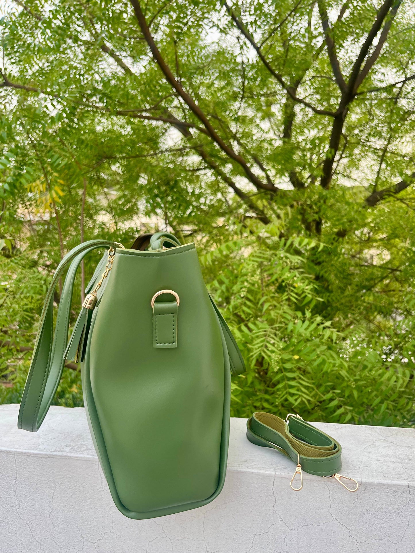 Graciza Aura green faux leather tote bag with gold-tone hardware, decorative tassel, and removable shoulder strap.