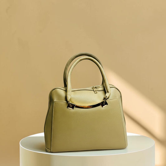 Graciza Elara beige faux leather handbag with twin handles and polished gold hardware on a circular display stand.
