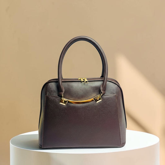 Graciza Elara structured handbag in chocolate brown faux leather with polished gold hardware and twin handles.