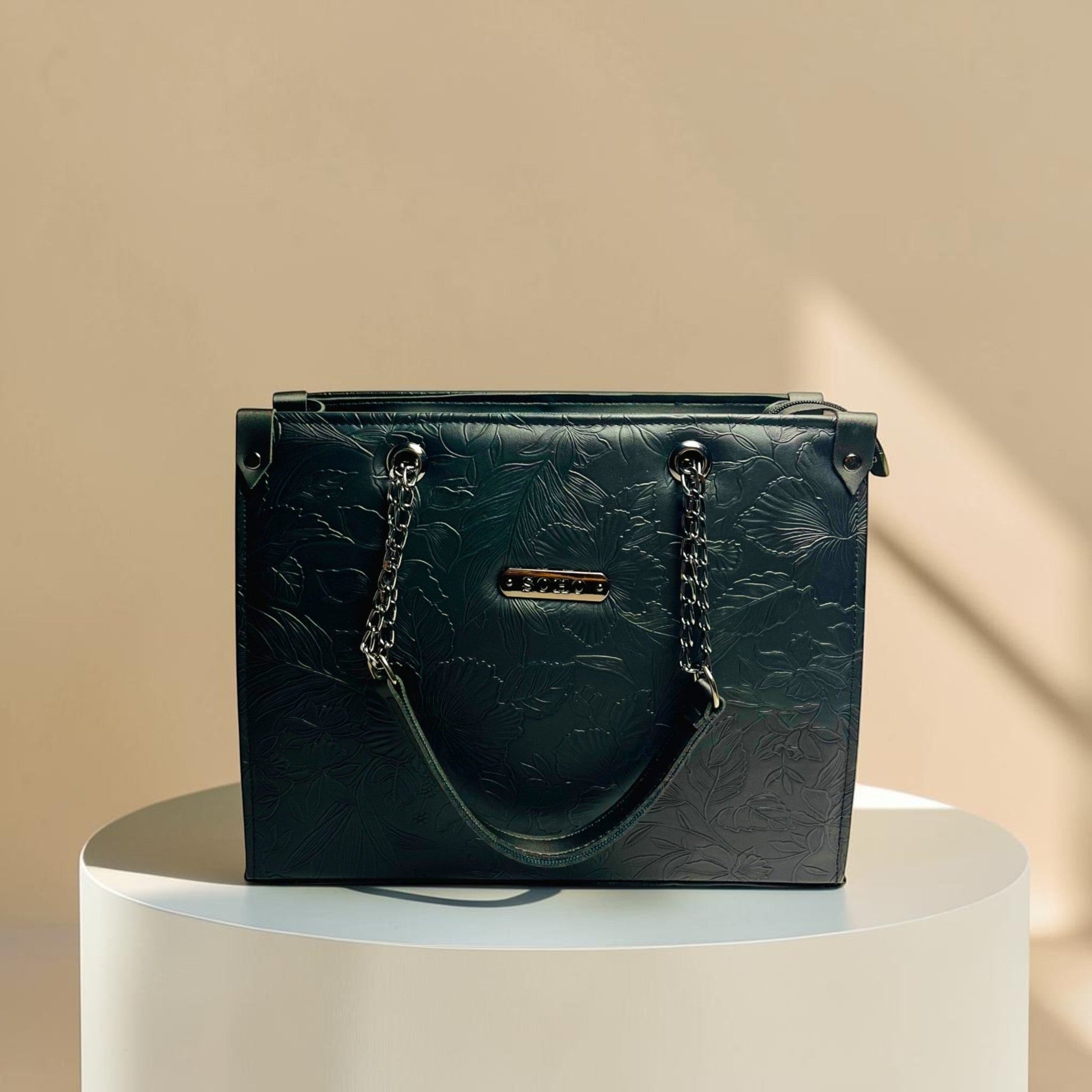 Graciza Flora black faux leather shoulder bag with floral embossed texture and decorative chain handle detail.