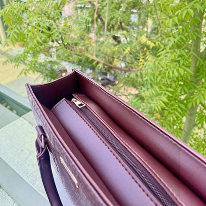 Graciza Lyra burgundy faux leather handbag with crocodile texture, gold zipper, and sturdy handles outdoors.