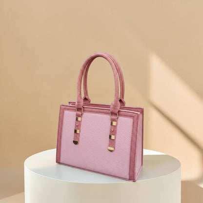 Graciza Sia handbag in two-tone pink faux leather with a structured square design and textured panels.