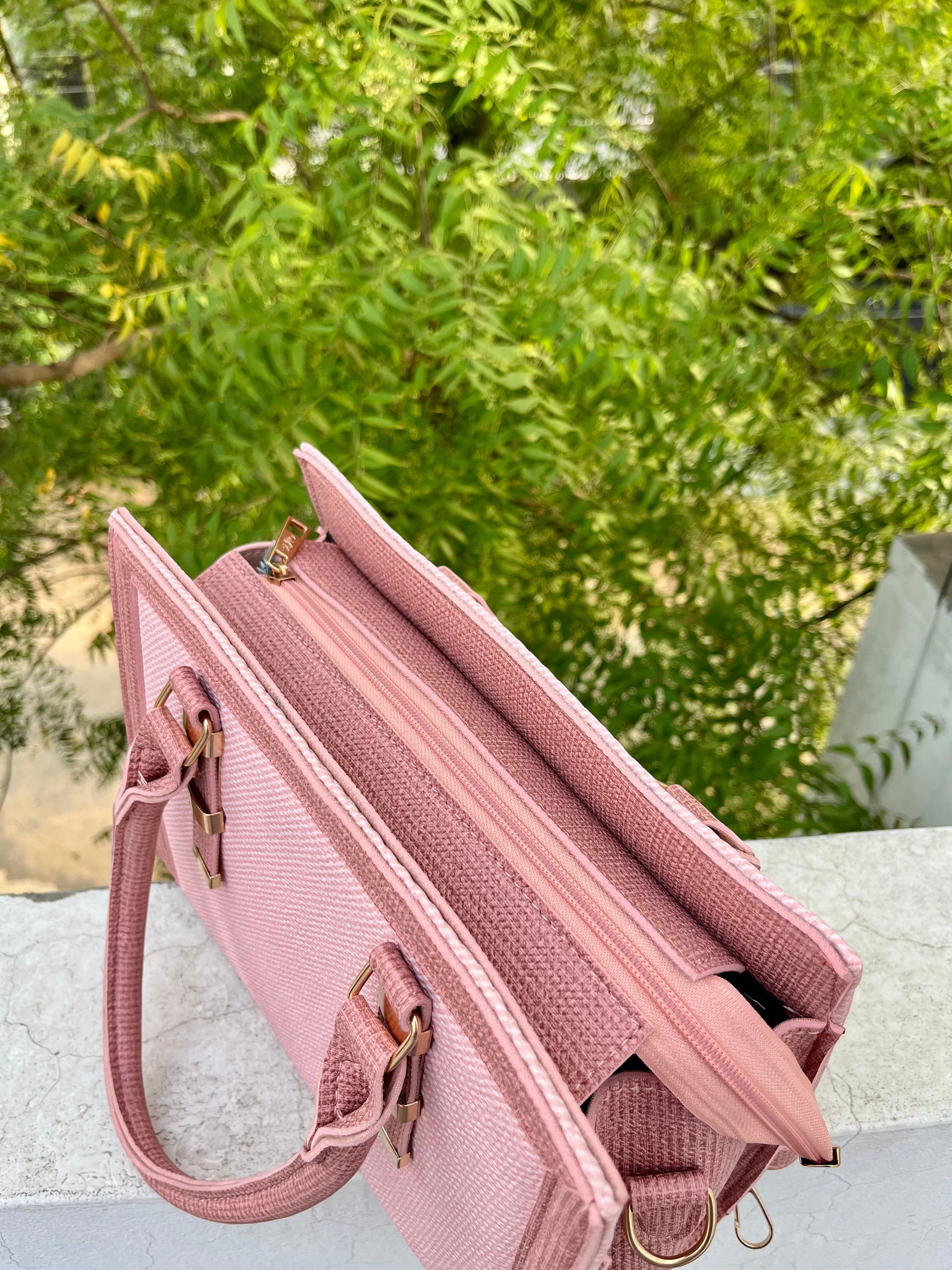 Graciza Sia handbag in soft pink faux leather with a structured square tote design and textured panel details.