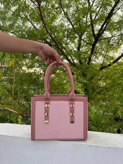 Graciza Sia square handbag in two-tone pink faux leather with textured panels and metallic handle accents.