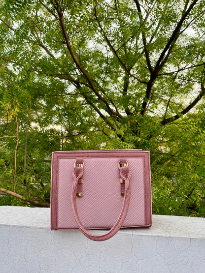 Graciza Sia pink faux leather square tote handbag with textured panels and double handles outdoors.